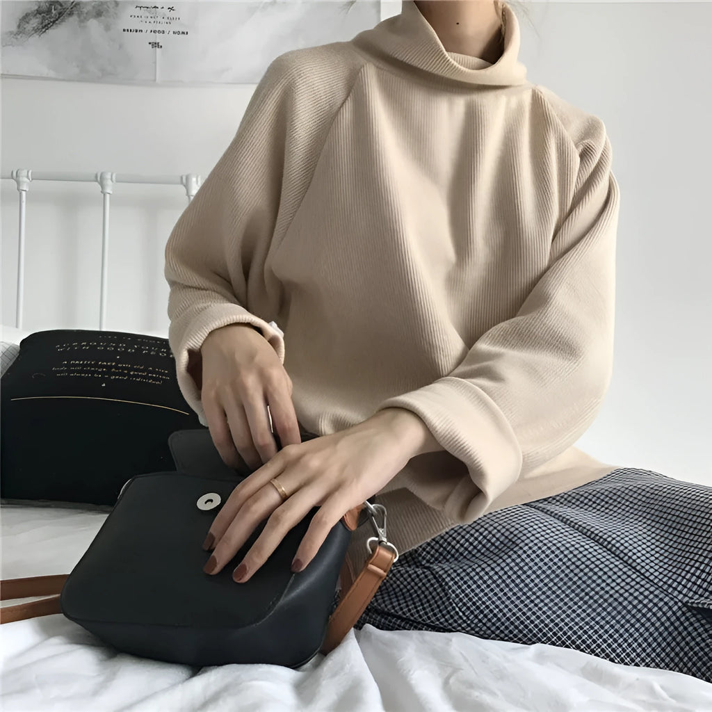 Women's loose fit long sleeve top with a half-high collar in white, apricot, or black.
