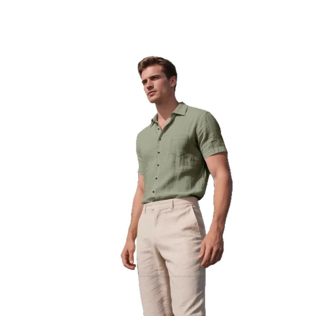 Man wearing a loose-fit, light blue, short-sleeved linen shirt in a cardigan style.