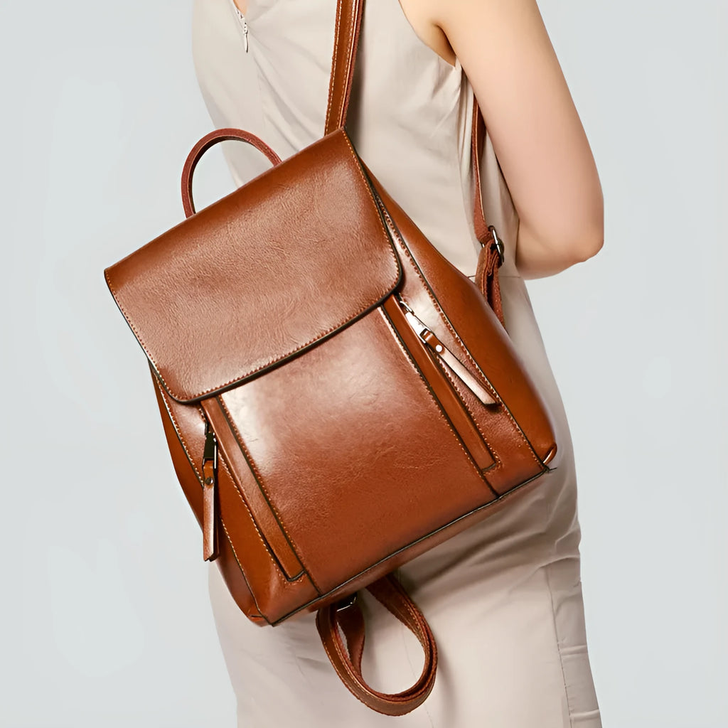 Large black genuine leather women's backpack with stitching detail and soft straps.