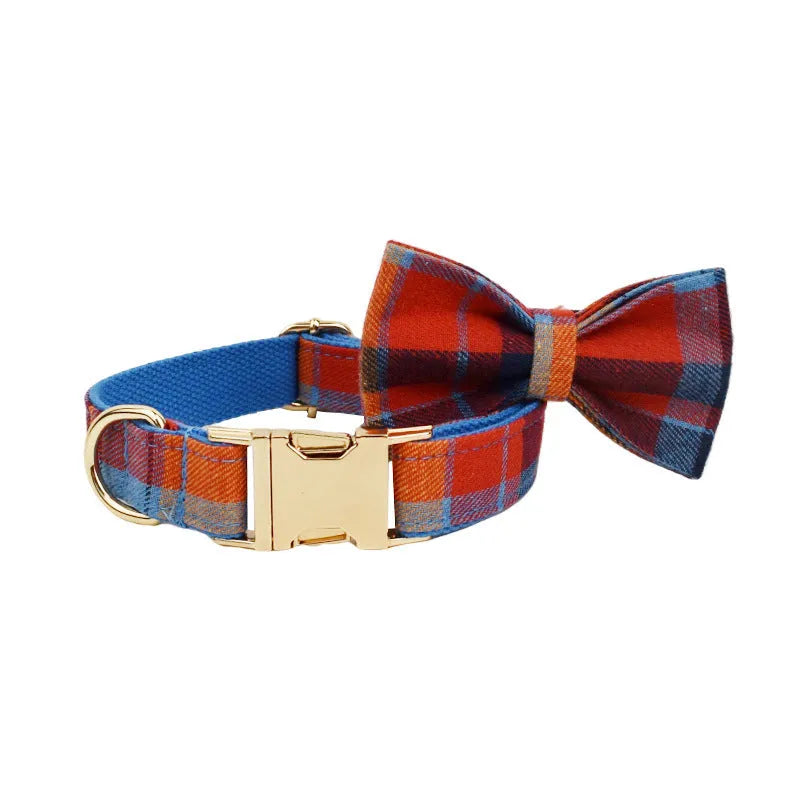 Blue background velvet plaid dog collar and matching hand holding leash on a white surface.