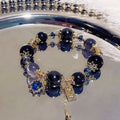 Women's galaxy colour bracelet with snowflake pendant, bow decoration, heart shapes and cartoon character details