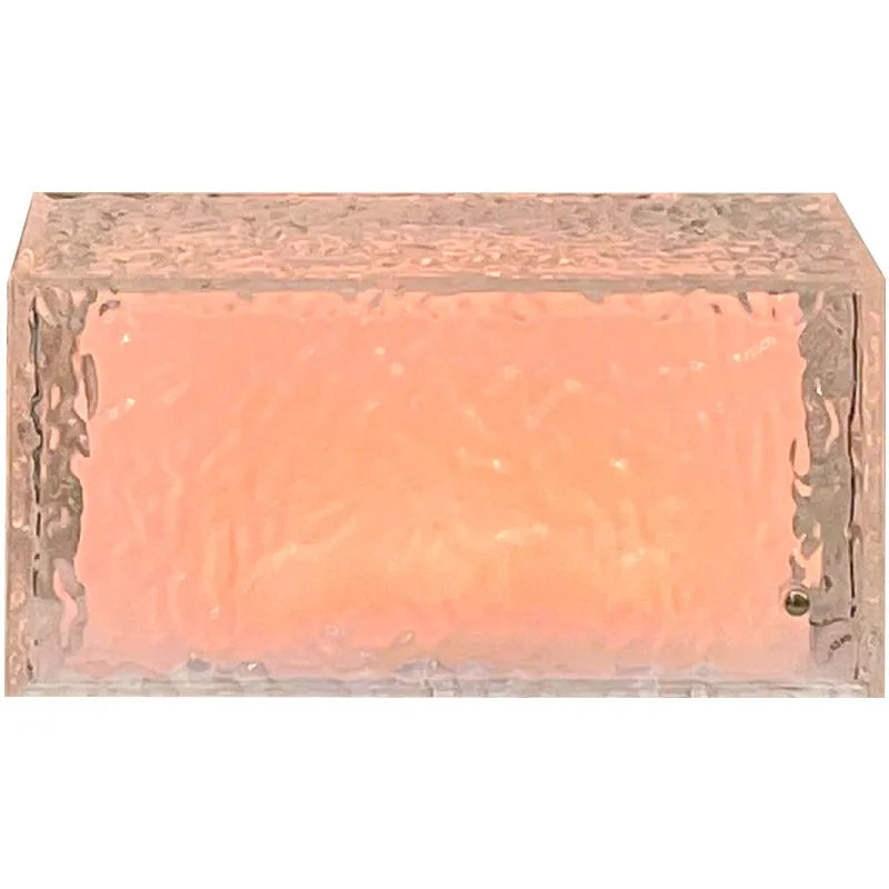 Geometric acrylic ice cube night light with colour changing LEDs on bedside table