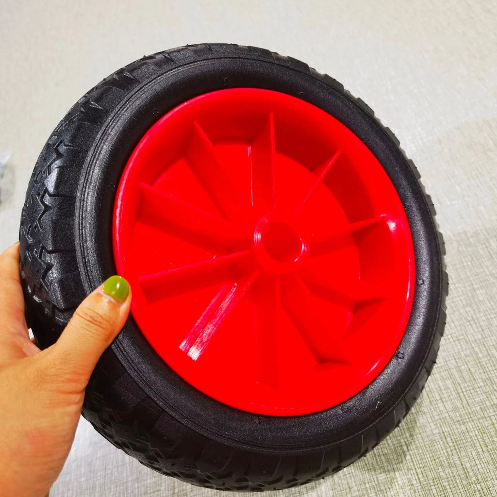 Foldable kayak beach trailer with aluminium frame and rubber wheels on sand.