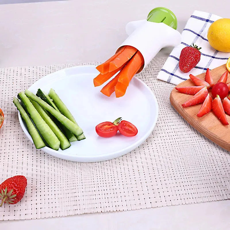 White kitchen slicer with six stainless steel blades for cutting cucumbers, carrots, and strawberries.