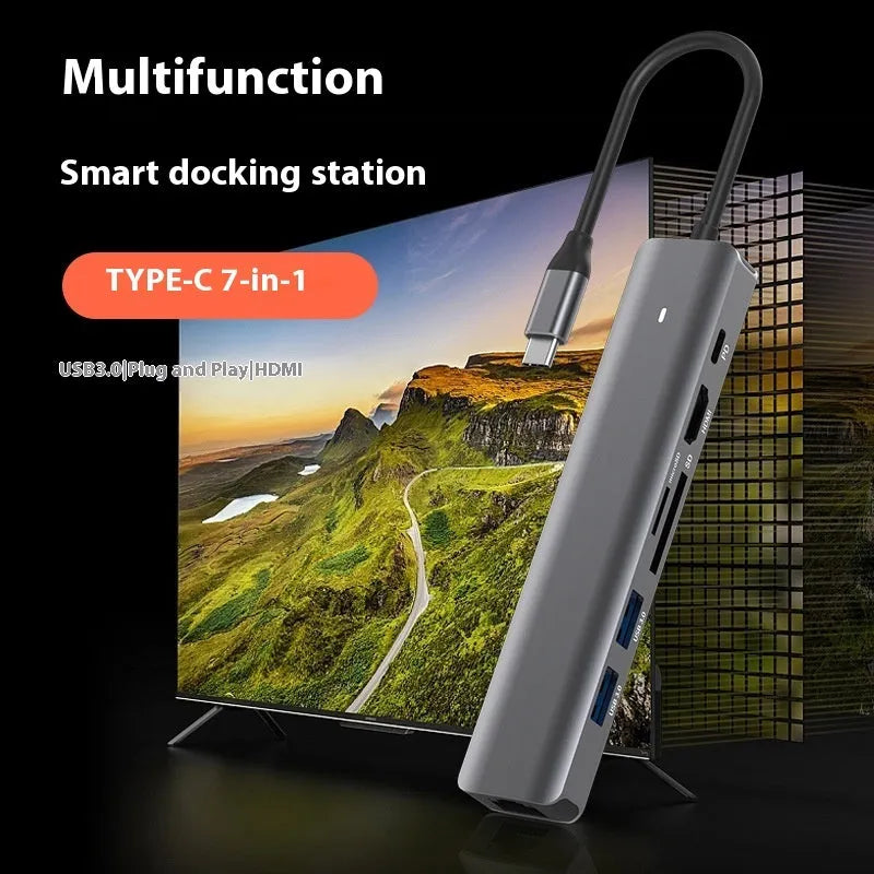 Silver 7-in-1 USB-C hub showing USB-C PD port, three USB ports, HDMI, and SD card slots.