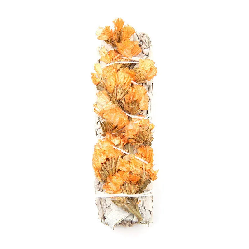 White sage and red rose petal colourful aromatherapy incense bundle on a wooden table