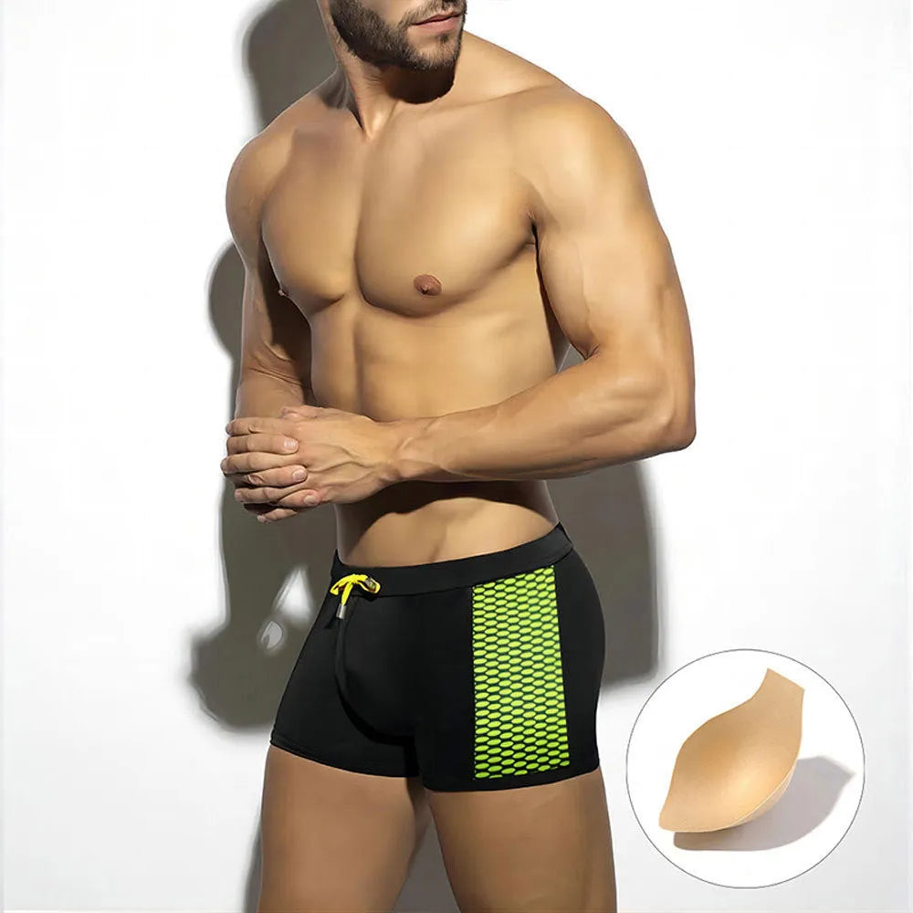 Yellow polka dot print men's swimming boxers on a mannequin, showing brief style.