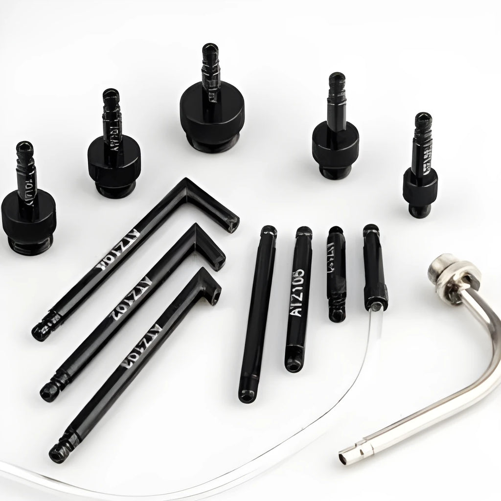 Thirteen-piece automatic transmission oil refuelling kit with pump tool and adapters on a workbench.
