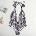 Women's leopard print bandage one-piece swimsuit with buckle detail and backless design.
