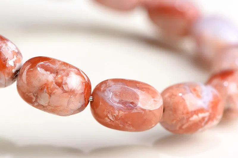 Natural cherry agate barrel bead bracelet with 10x14mm stones and Ruyi design elements