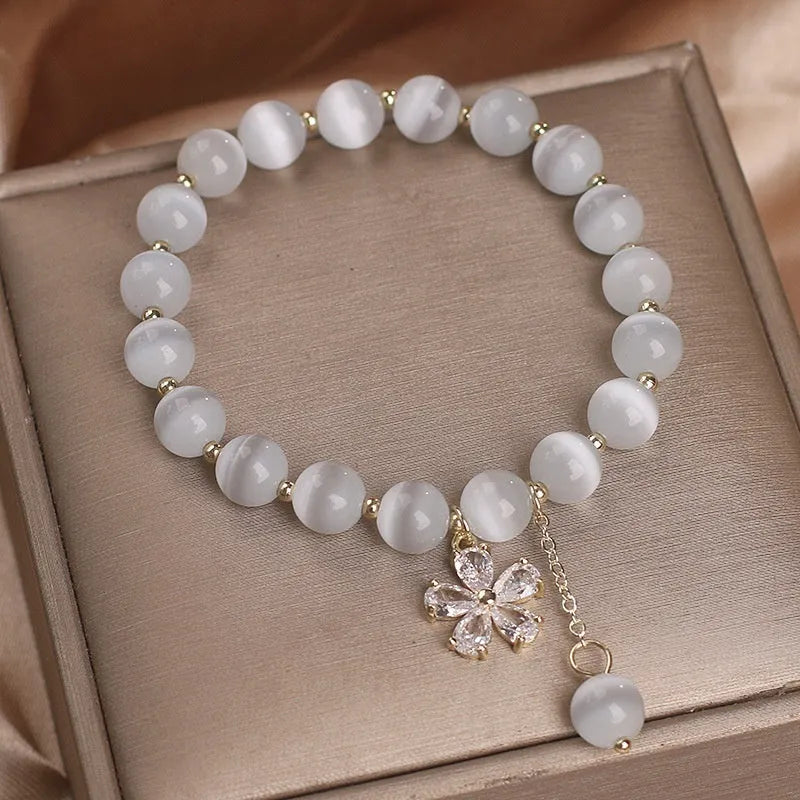 Women's white cat's eye crystal bracelet with floral tassel and morganite safety buckle pendant