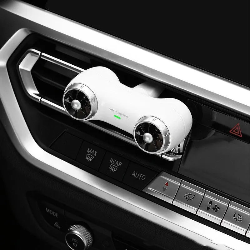 Black and white compact car air purifier and aromatherapy diffuser unit with USB Type-C cable.