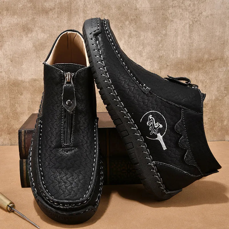 Men's black slip-on leather loafers with round toe and rubber sole on a white background