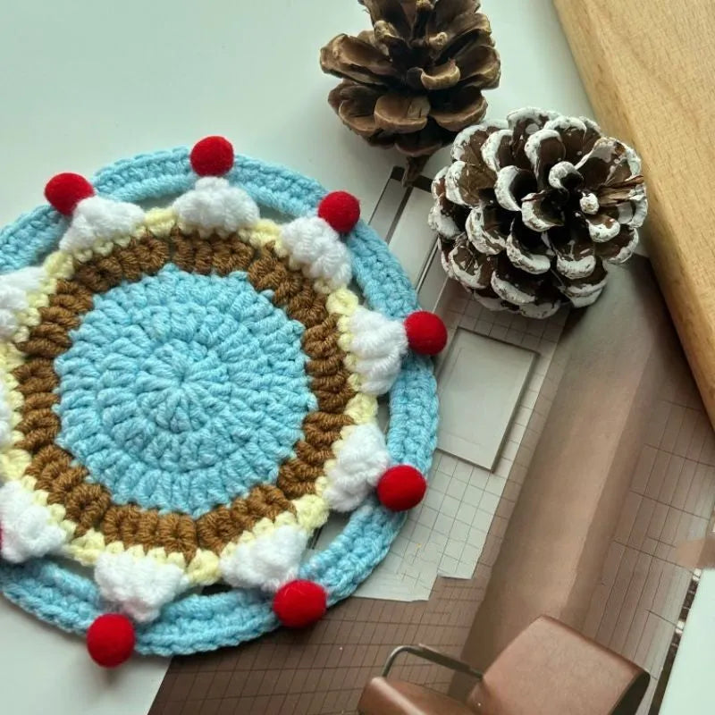 Handmade round wool coaster bag for hot mugs on a table