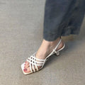 Retro light brown women's high heel sandals with thin cross straps and an ankle buckle.
