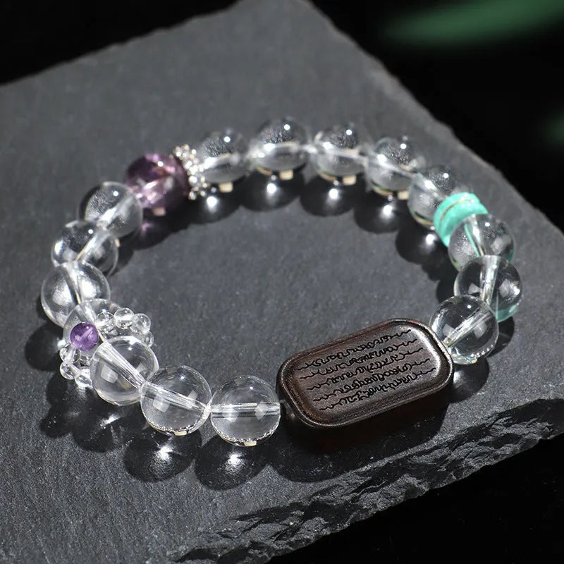 Handmade natural white crystal ebony bracelet with five warp design on wooden background