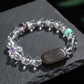 Handmade natural white crystal ebony bracelet with five warp design on wooden background