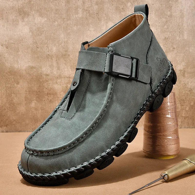 Handmade men's black synthetic leather slip on shoes with a flat heel on a plain background.