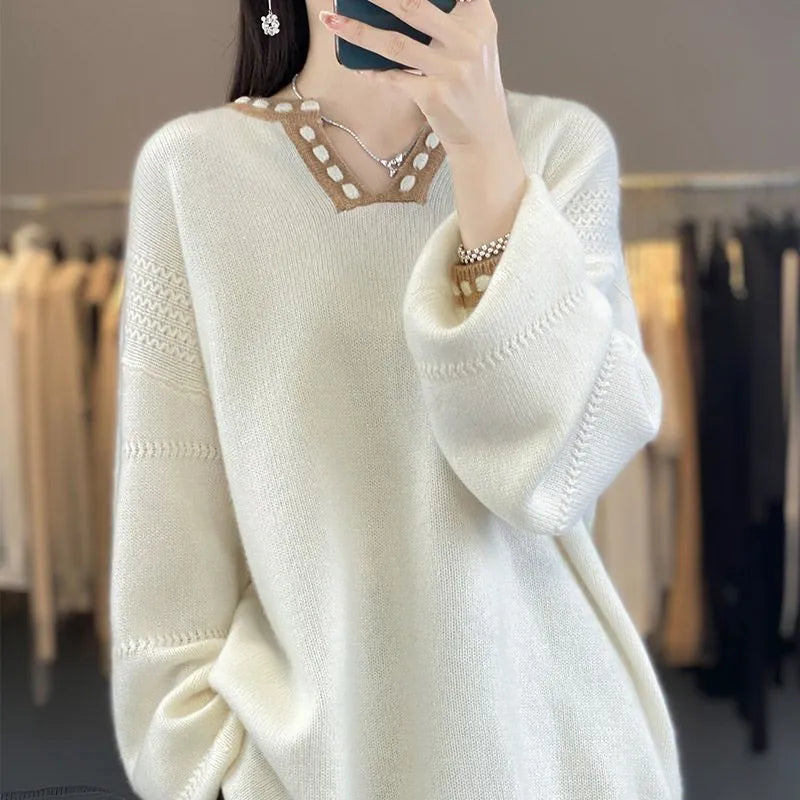 Women's camel coloured V-neck pullover sweater with long sleeves on hanger