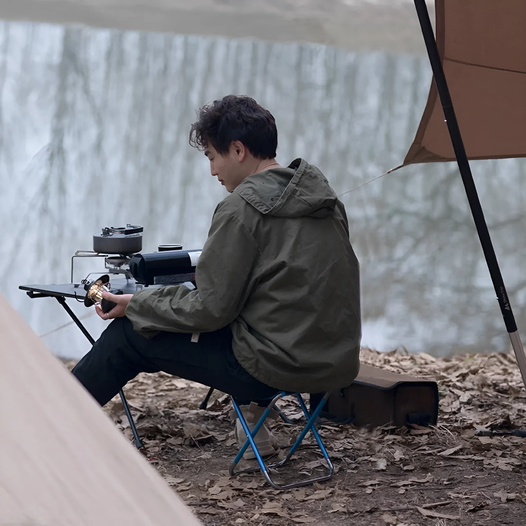 Black aluminium alloy folding camping stool in folded and unfolded positions