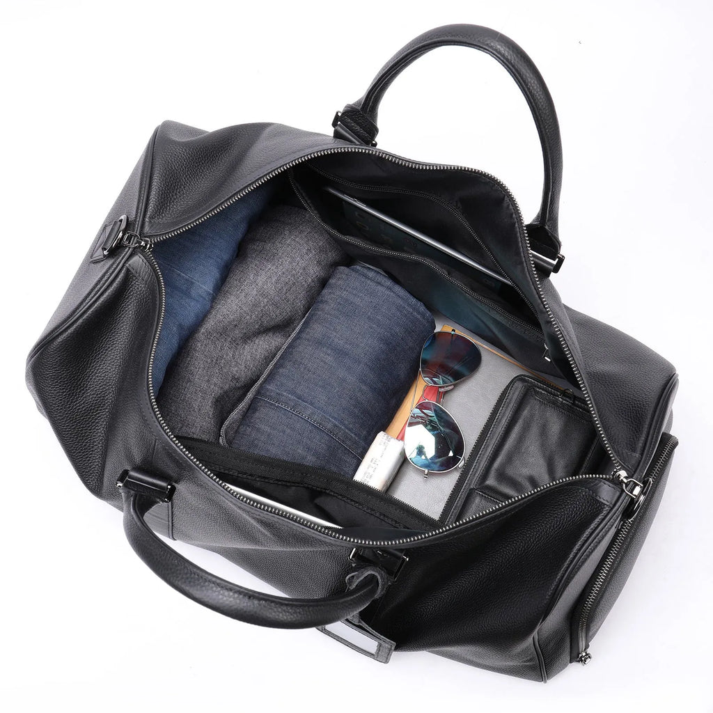 Men's black leather excursion bag with single shoulder strap showing spacious interior