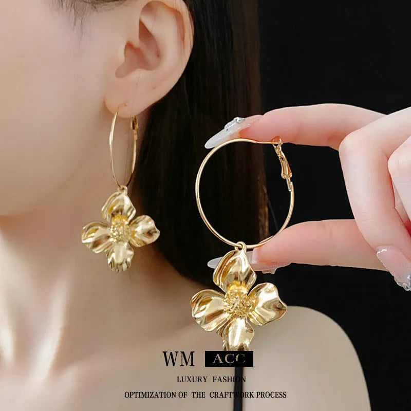 Gold and silver vintage metal flower earrings with geometric design and a silver needle detail.