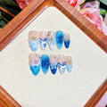 Blue hand-painted carved transparent fake nails set in sizes XS, S, M, L.