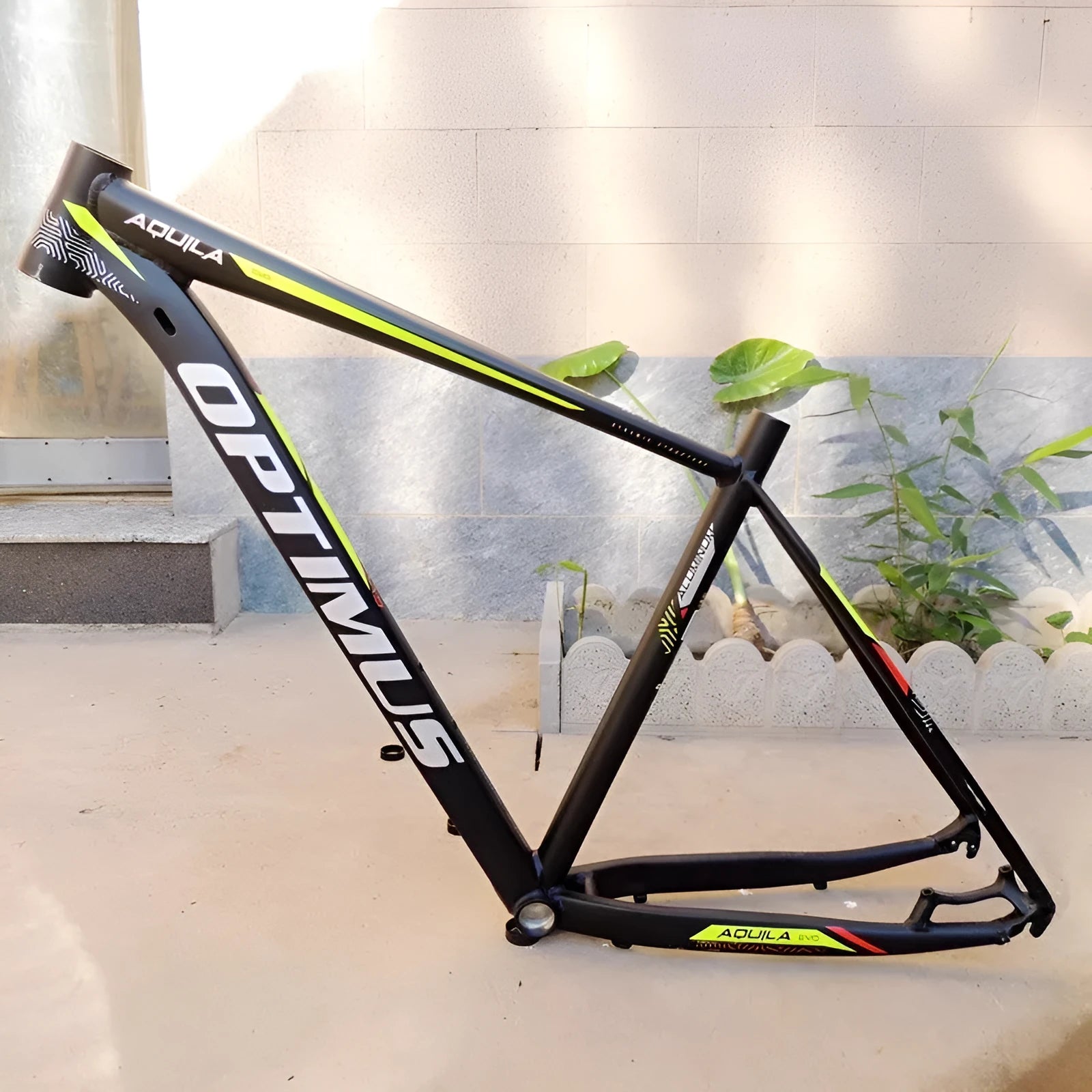 Black green aluminium mountain bike frame for 29-inch wheels with inner cable routing and disc brake mounts.