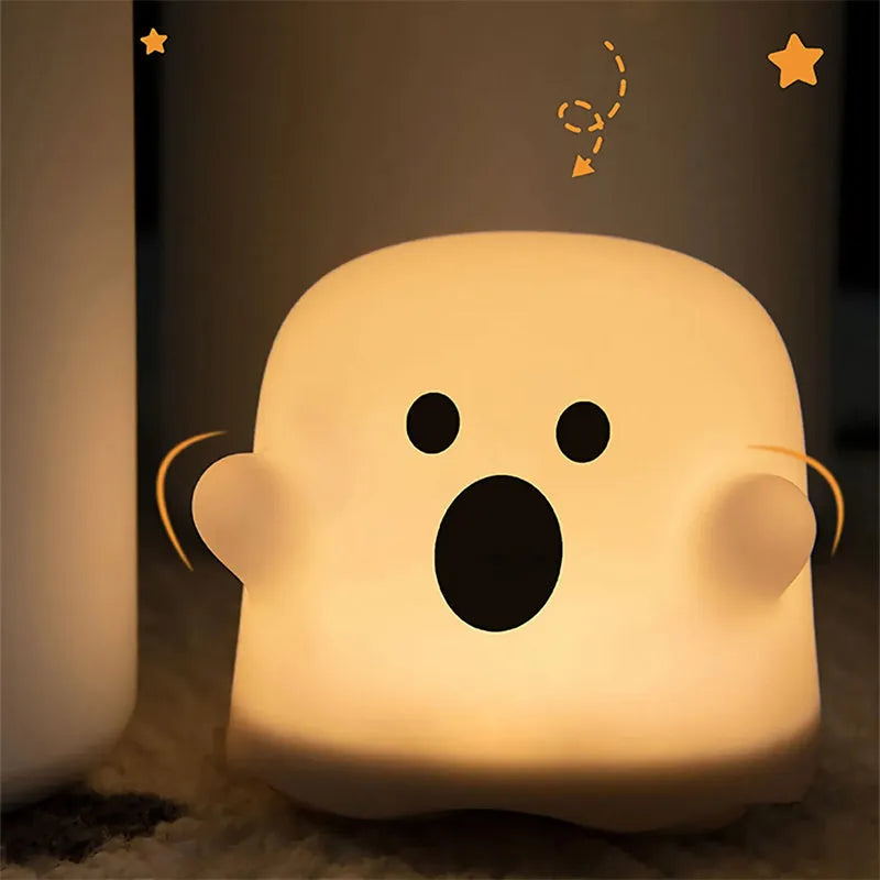 White portable LED touch sensor night light on a wooden bedside table.