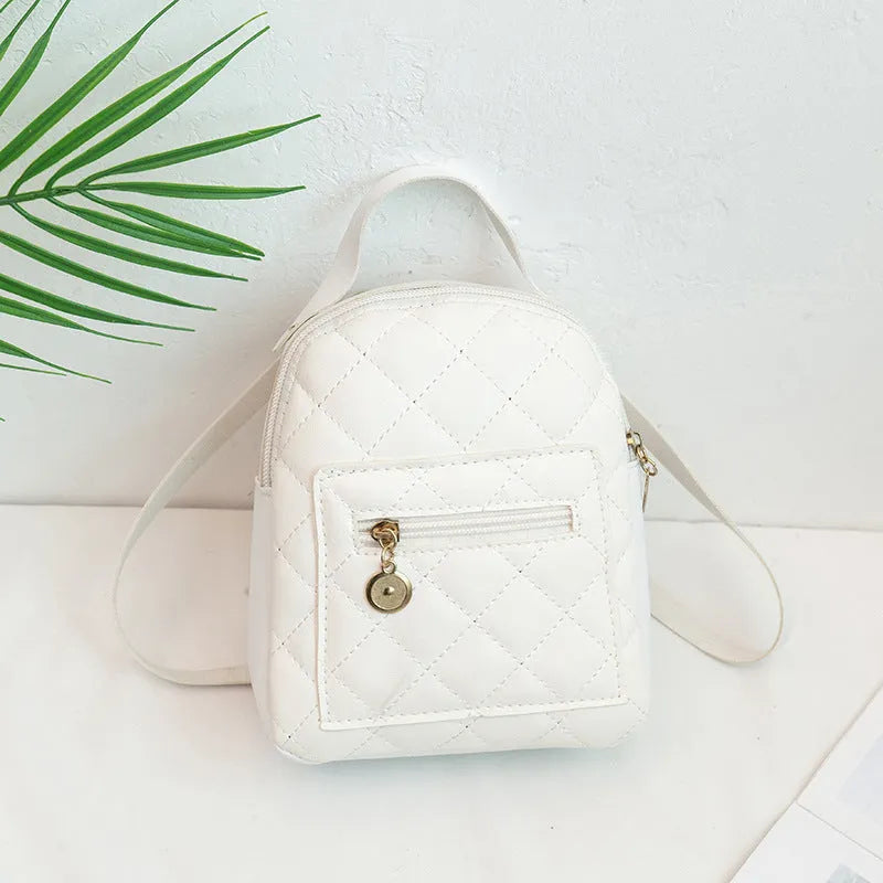 Small white embroidered hardback girls' backpack in a vertical square shape on a plain background.