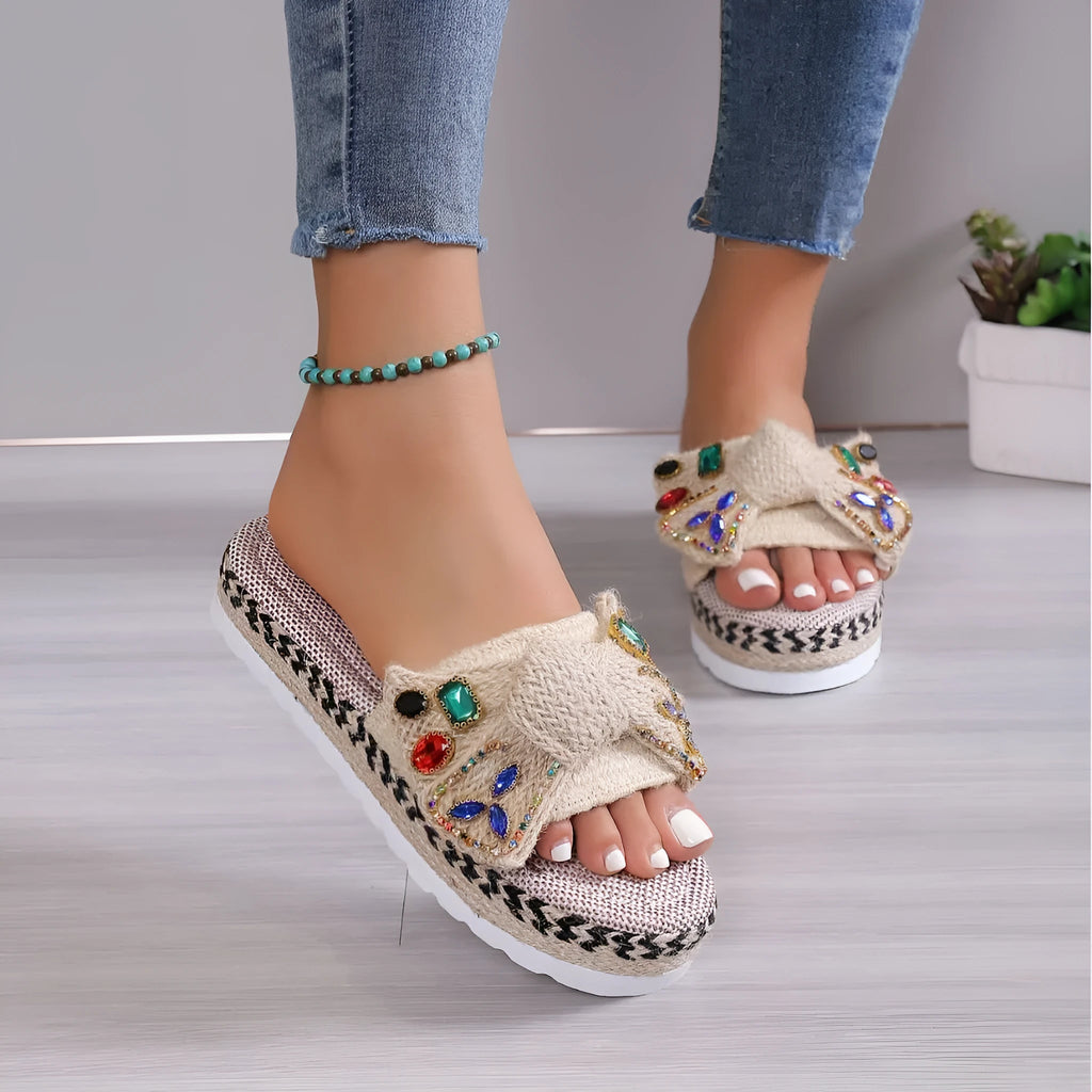 Creamy-white women's platform sandals with a cloth upper, beach bow detail, and slip-on sleeve design.