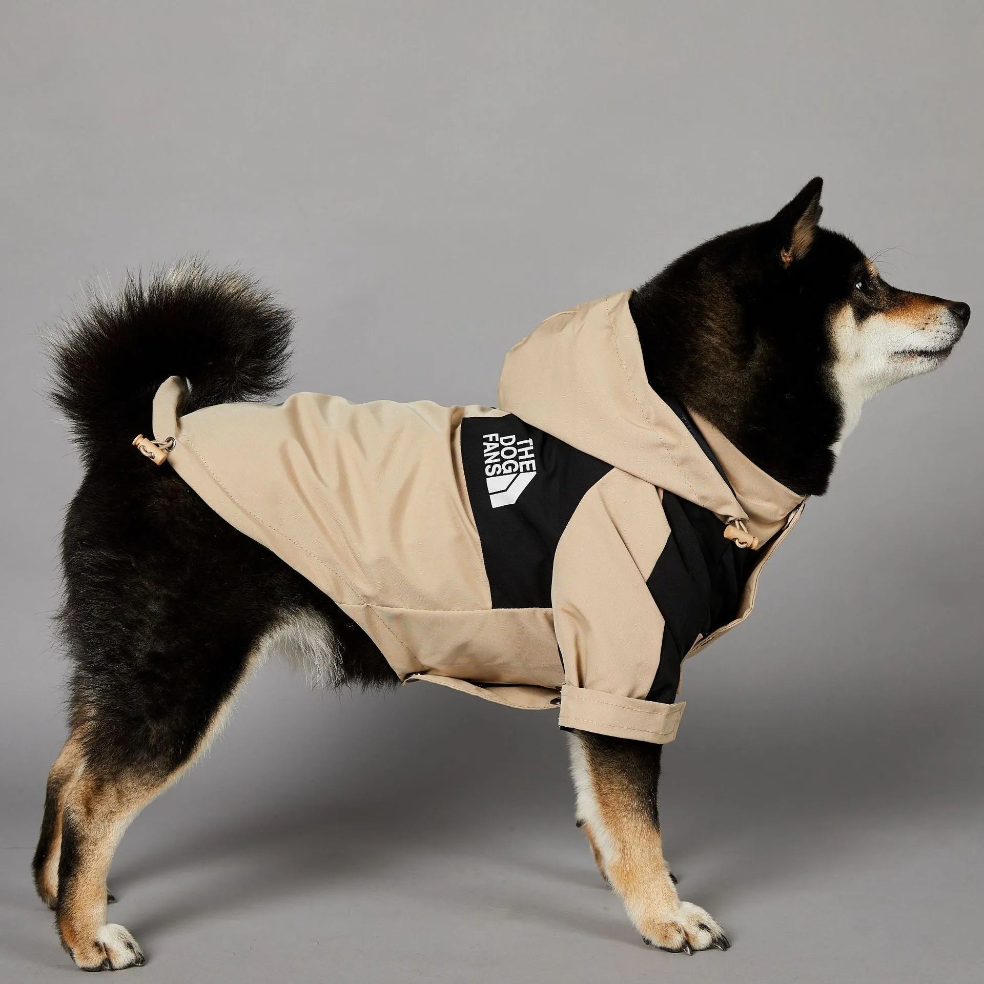 Khaki coloured polyester dog shell jacket shown on mannequin, back and side coverage design