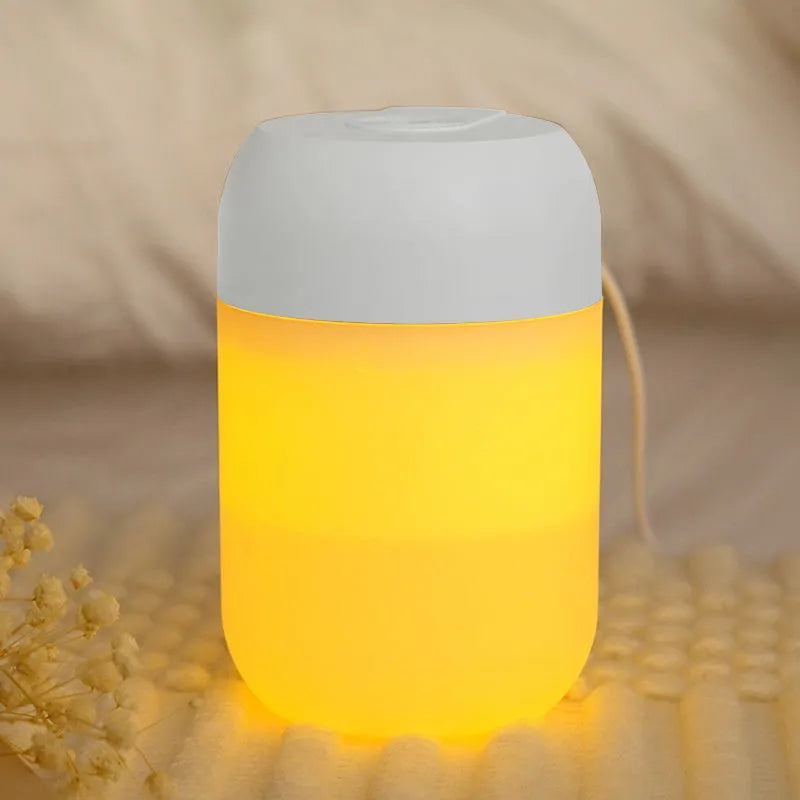 Small white cylindrical USB humidifier with charging cable for bedroom or desk use
