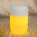 Small white cylindrical USB humidifier with charging cable for bedroom or desk use