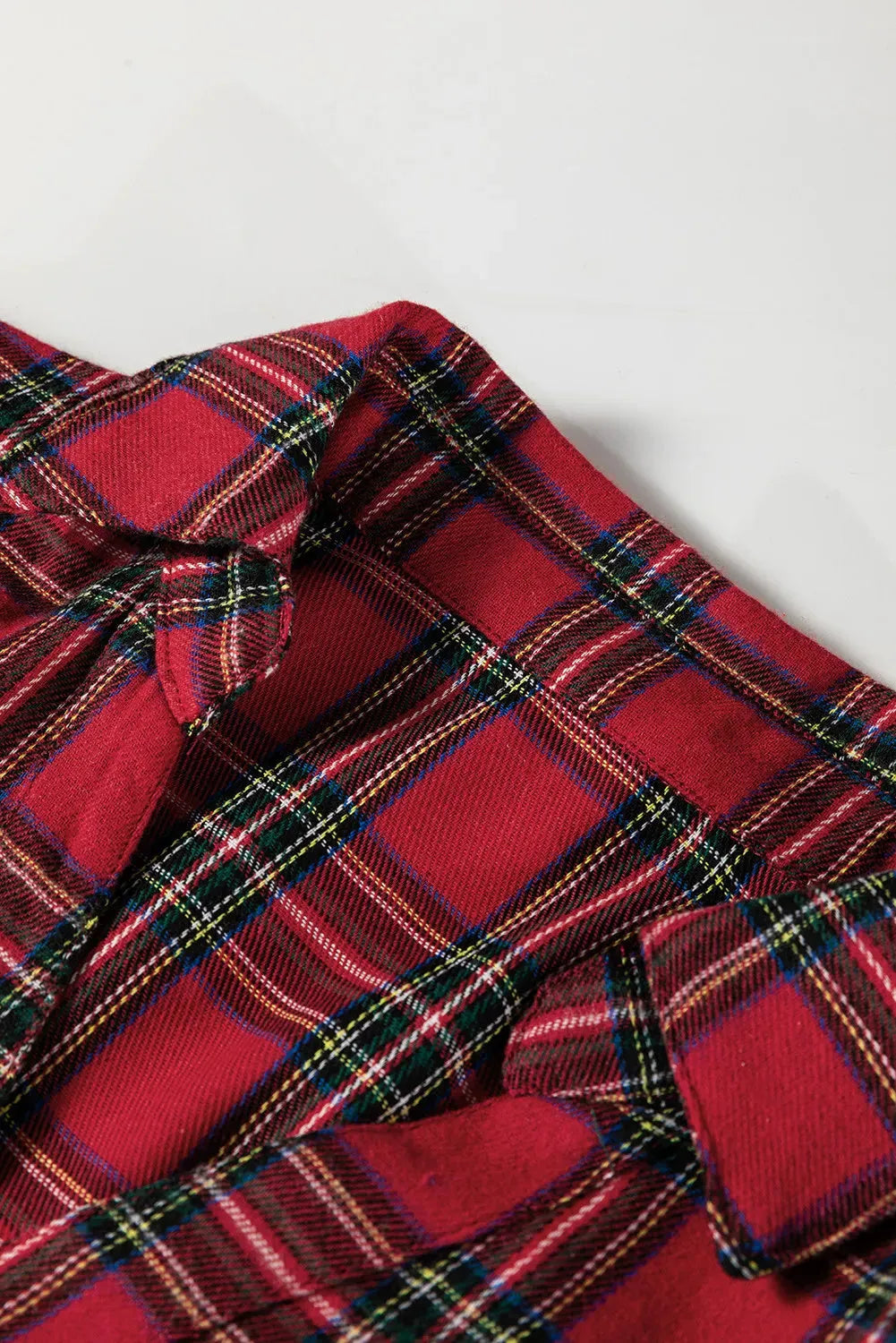 Red plaid shirt collar mini dress with long sleeves, half-button front, and ruffle hem.