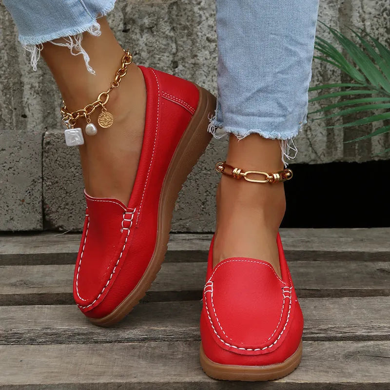 Women's flat loafer in PU leather with round toe and car suture detail, shown in multiple colours.
