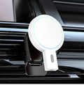 White magnetic wireless phone charger on desk with mobile phone attached