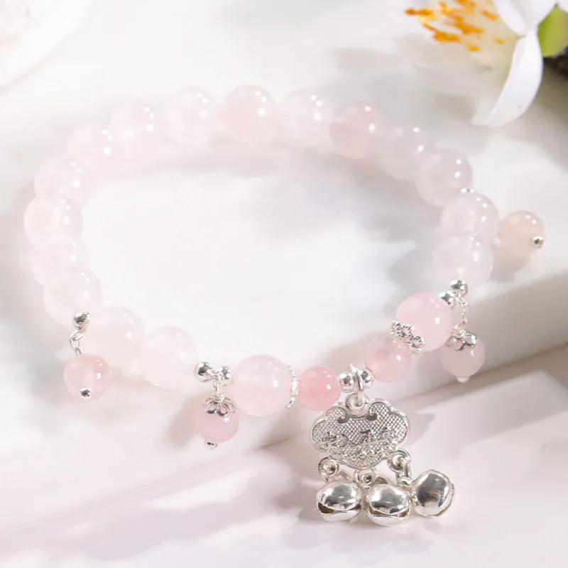 Women's opal cat's eye stone bracelet with diamond-shaped beads on wrist.