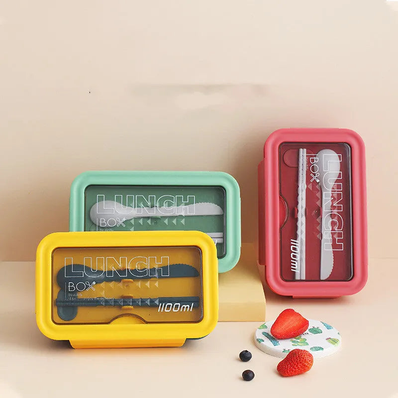 Green Japanese bento box with four separate food compartments and Nordic-style design