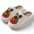 Black and white Halloween pumpkin plush house slippers with non-slip rubber soles.