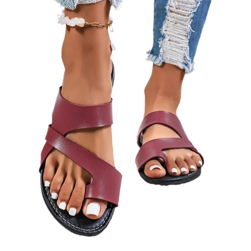 Solid colour round toe beach slippers with a one-strap design and perforated hollow out details on the sole.