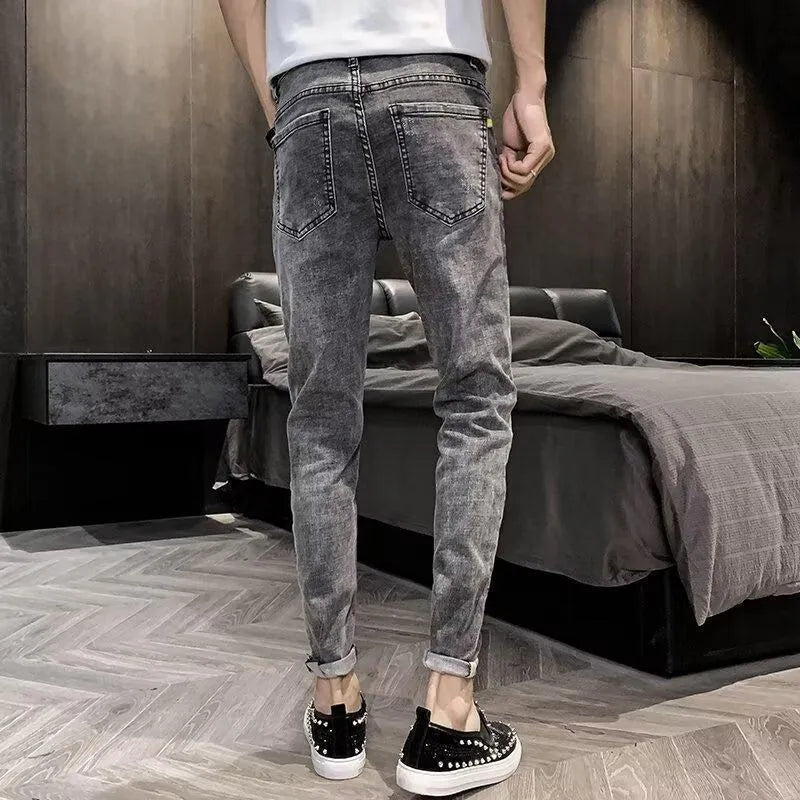 Men's high-waist blue denim jeans with button fly and standard trouser length on mannequin