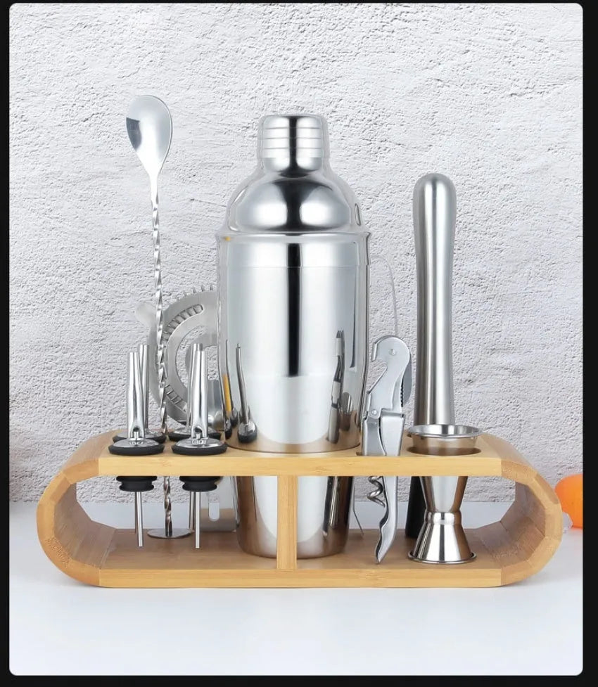 23-piece stainless steel and acrylic European style cocktail mixing set on a bar.