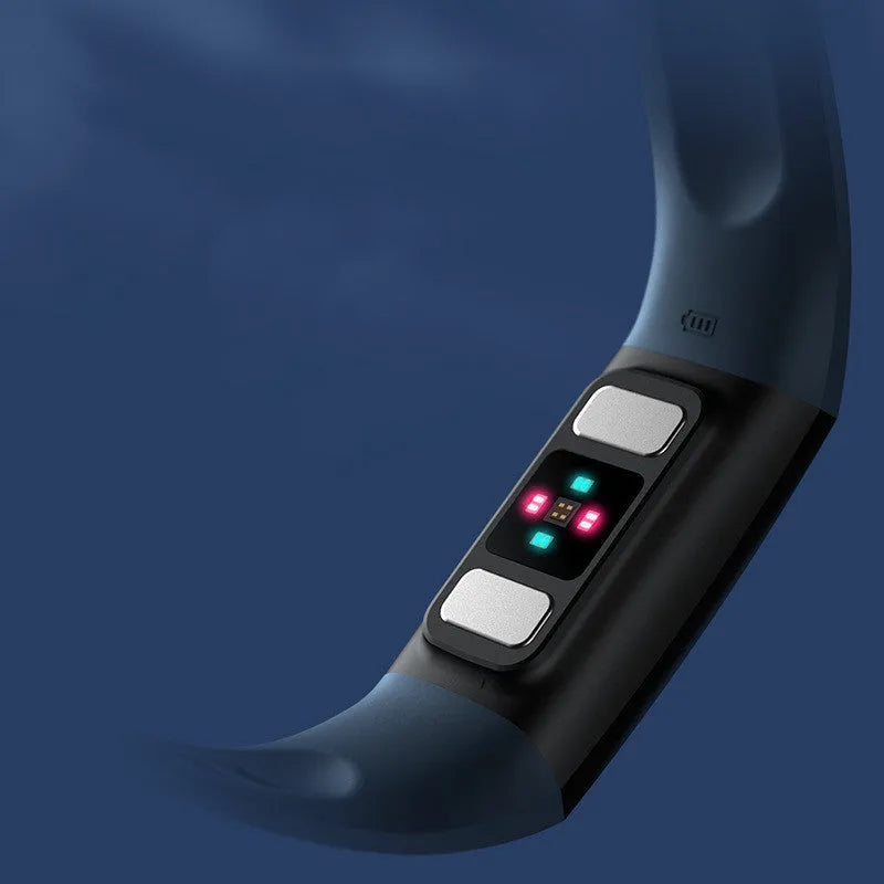 Black smart bracelet on wrist showing blood pressure and heart rate data on its 1.1-inch screen.