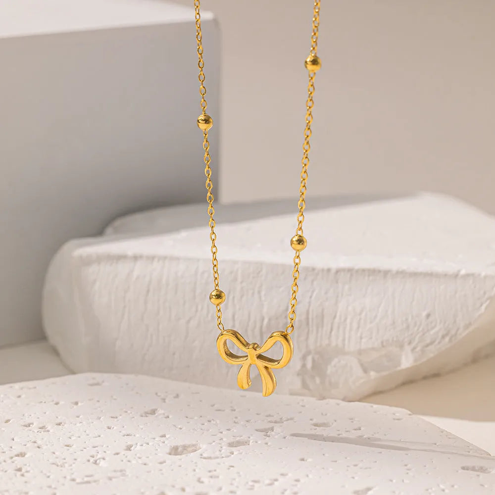 Gold bow necklace on adjustable 41-50cm titanium steel chain with cross link design