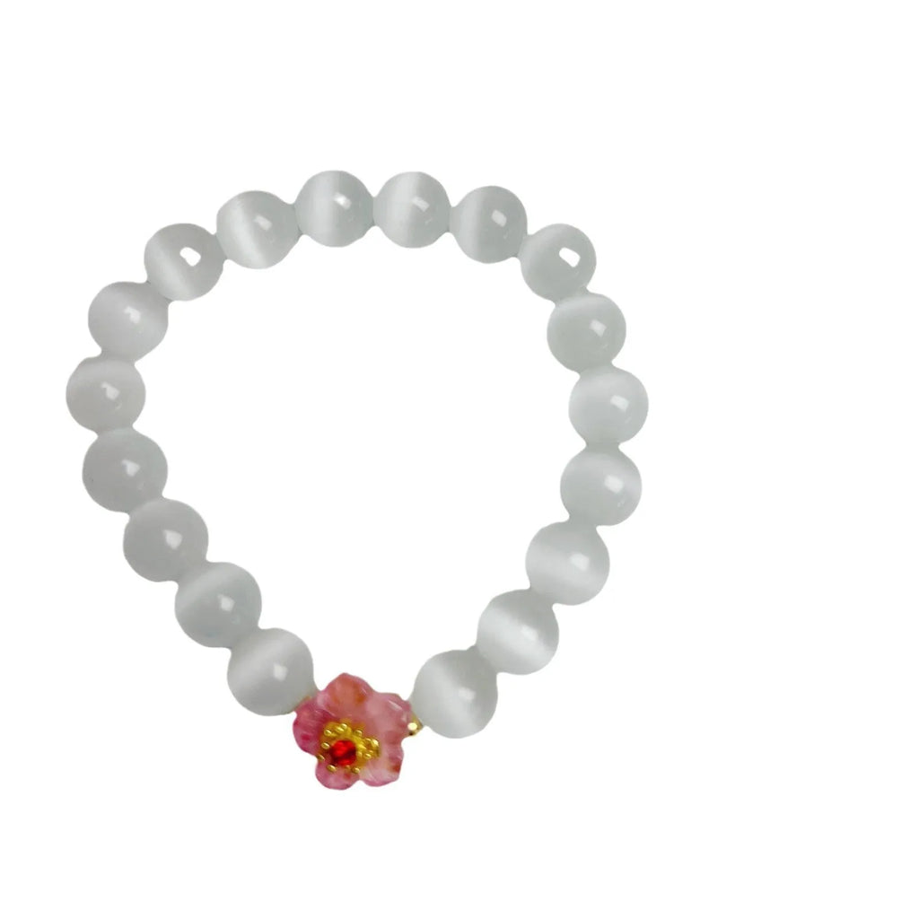 Handmade glass bead bracelet with flower design for women in yellow, pink, white, or green.