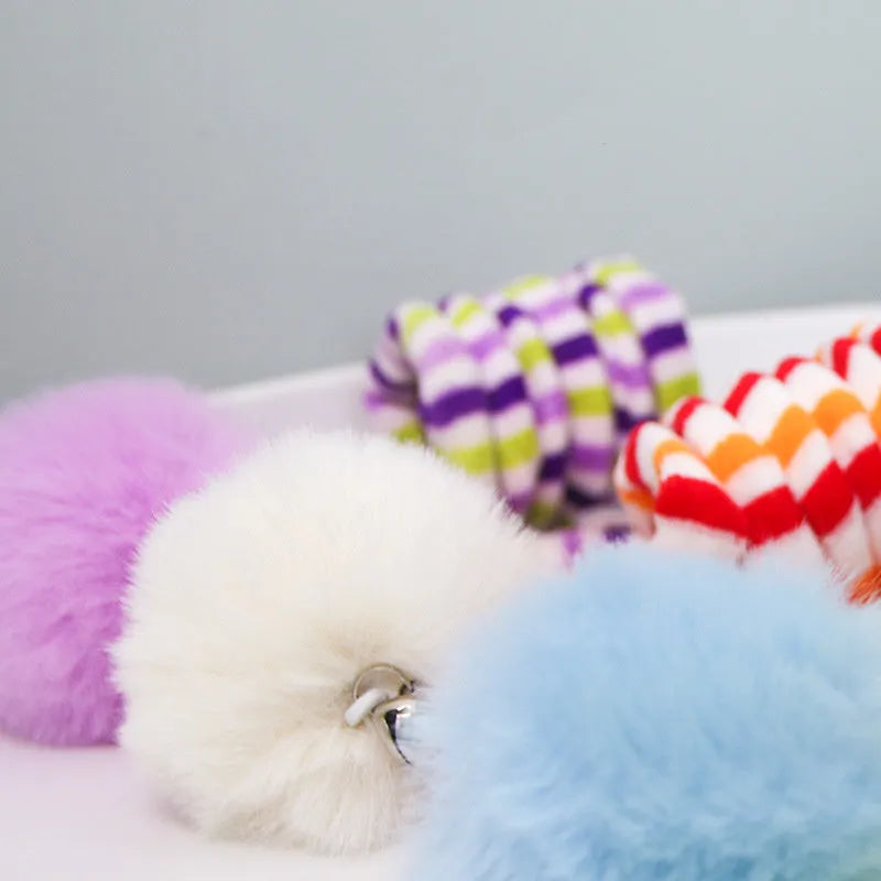 Hanging cat toy with colourful inflatable ball and bell stick mounted on door with suction cup