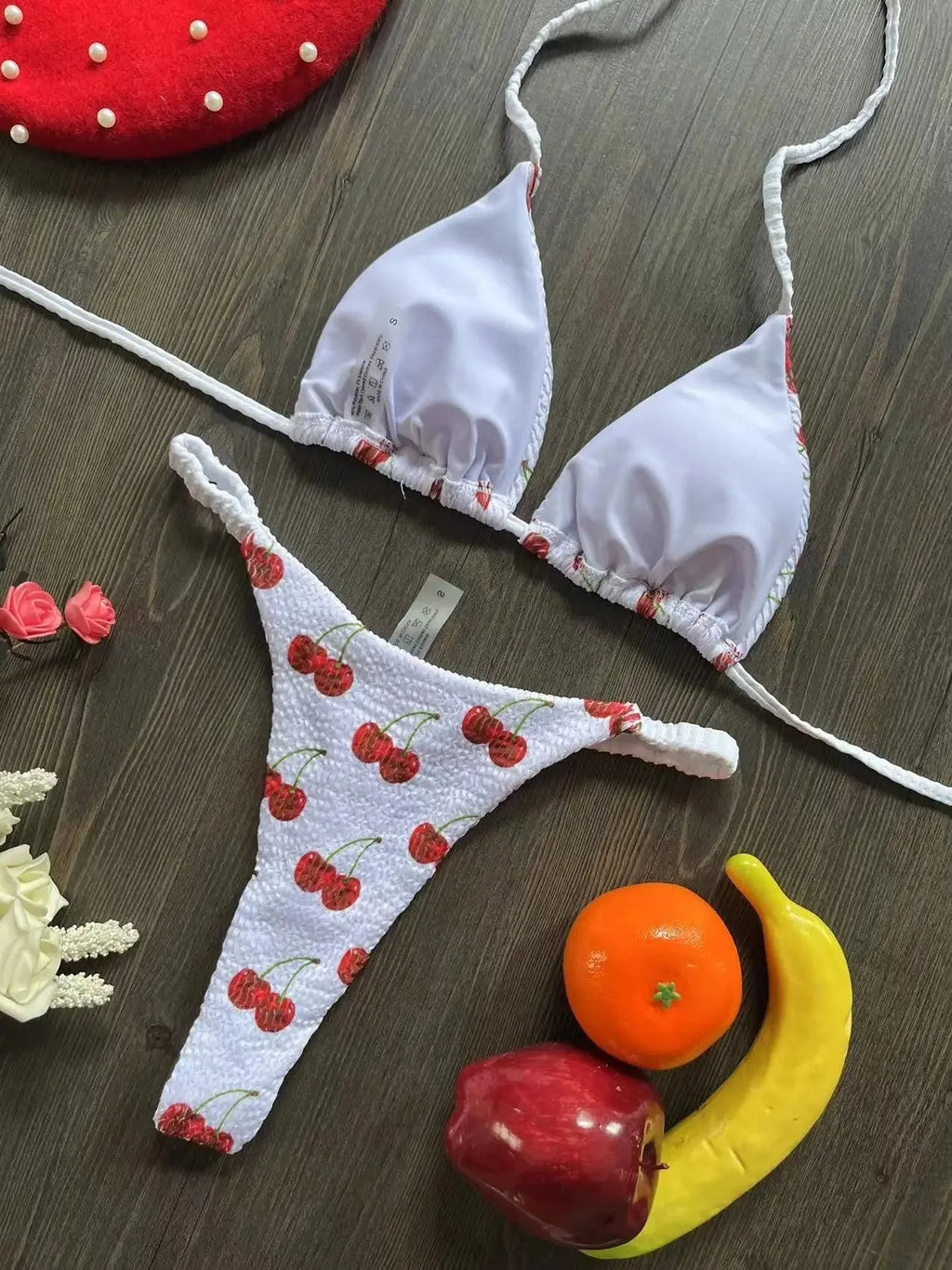 Women's printed bikini swimsuit on a hanger, showing briefs style and cotton lining detail.