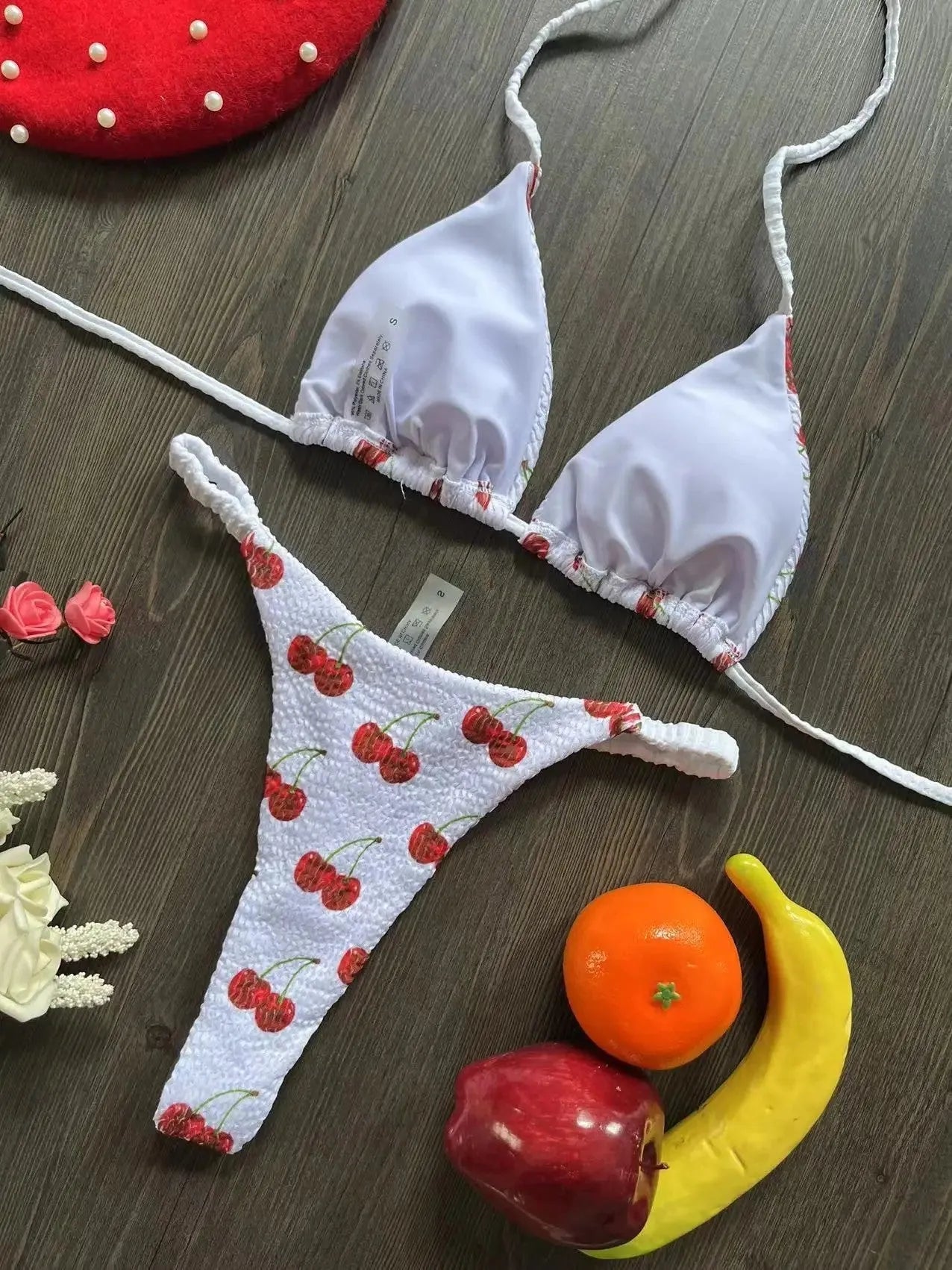 Women's printed bikini swimsuit on a hanger, showing briefs style and cotton lining detail.