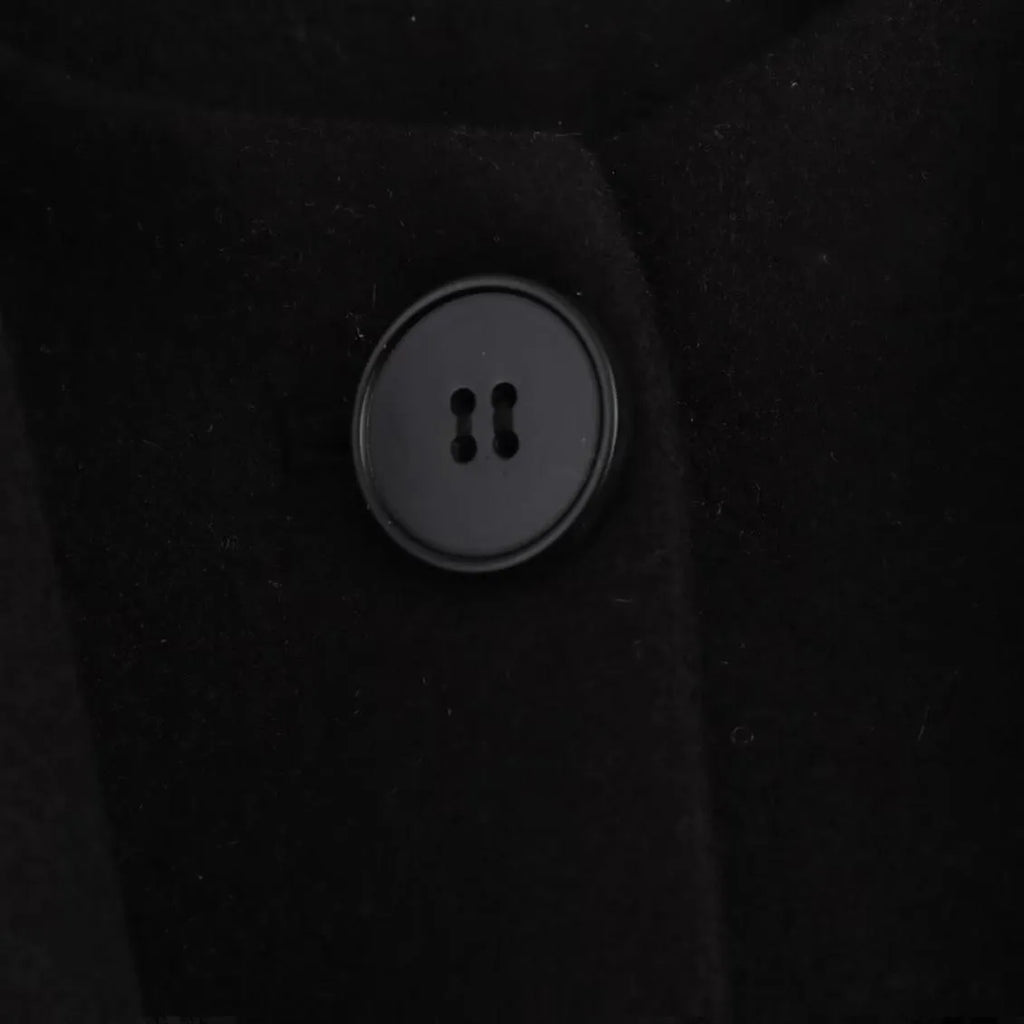Long grey women's polyester overcoat with a black faux fur collar on a hanger.